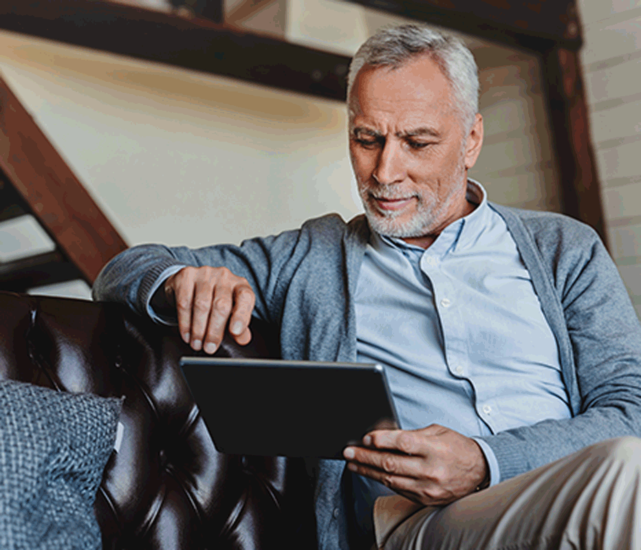 A man using a tablet to check his test results and know his level of risk for alpha-1 antitrypsin deficiency