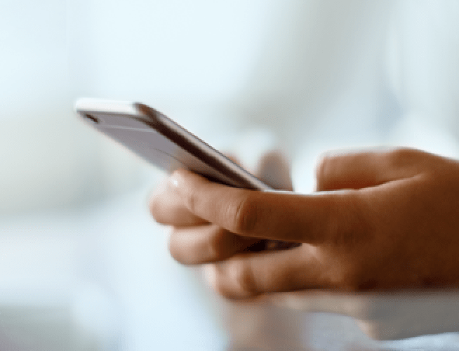 A person using his smartphone to order an AlphaID Confirm test kit